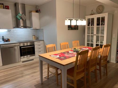 a kitchen with a dining room table and chairs at Rovaniemi city Apartment in Rovaniemi