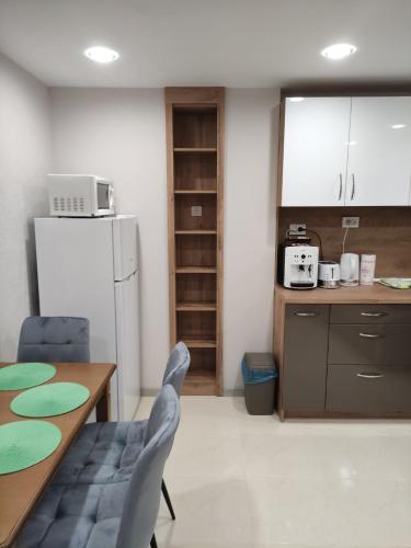 a kitchen with a table and chairs and a refrigerator at Downtown in Ruse