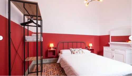 a red bedroom with a bed and red walls at Casa Guadalupe y Roque in Santa Cruz de Tenerife