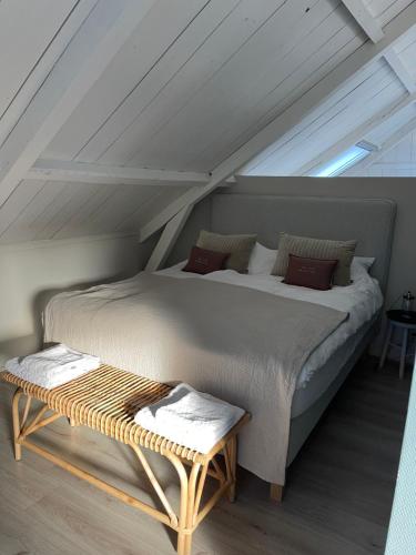a bedroom with a large bed and a table at Bij Risje dorp in Ballum