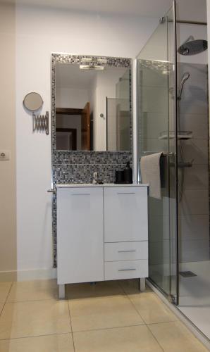 a bathroom with a white vanity and a mirror at Vivienda vacacional Rous in Los Llanos de Aridane