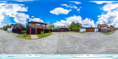 a driveway with a house and a fence at mirabosque new aparments 4 in Osorno