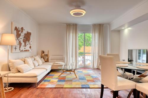 a living room with a couch and a table at Encarnação Funchal, a Home in Madeira in Funchal