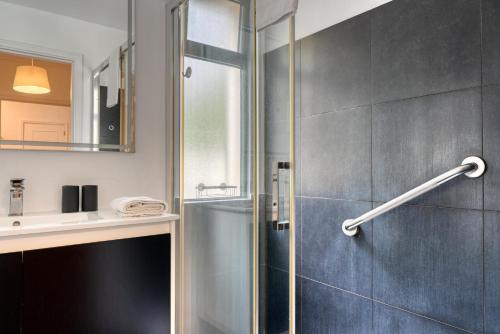 a bathroom with a shower and a sink at Encarnacao Apartment, a Home in Madeira in Funchal