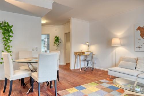 a living room with a table and chairs and a couch at Encarnação Funchal, a Home in Madeira in Funchal