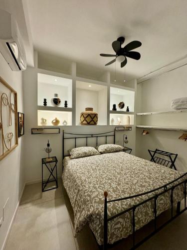 a bedroom with a bed and a ceiling fan at The Place in Bologna