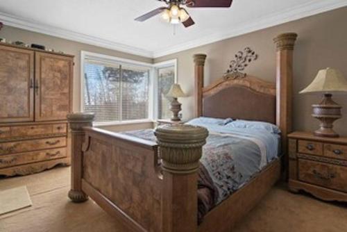 a bedroom with a large bed and a window at Cozy Home with a View on Acre in Abbotsford
