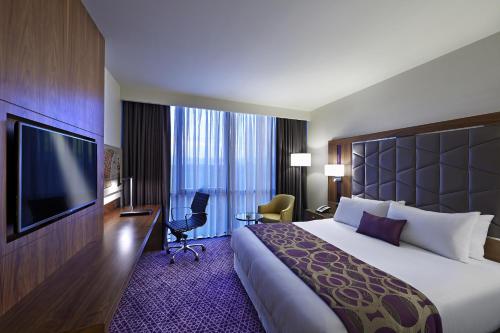 a hotel room with a large bed and a flat screen tv at Uranus Istanbul Topkapi in Istanbul
