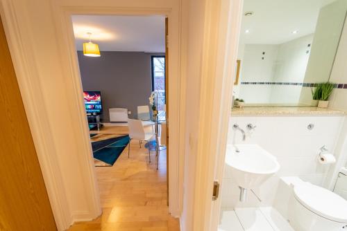 a bathroom with two sinks and a dining room at Superb 1 Bedroom Serviced Apartment In City Centre in Birmingham