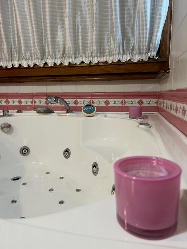 a white bath tub with a purple bowl in it at Villa Attoni Di Canossa in Anzio