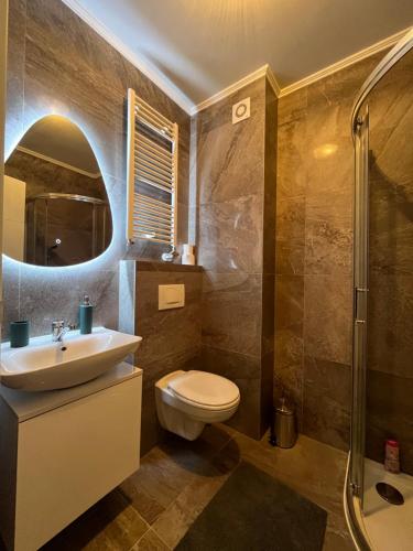 a bathroom with a toilet and a sink and a shower at Apartman Vista Banja Luka in Banja Luka