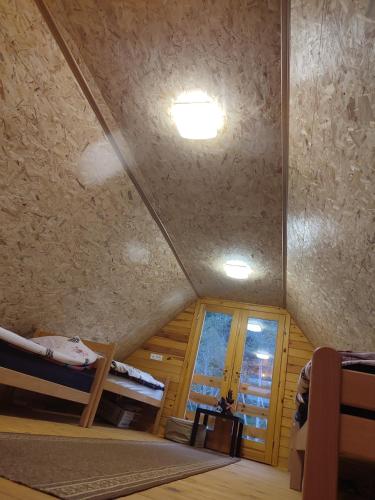 a room with two bunk beds and a window at Vikendica Jankovic in Pale