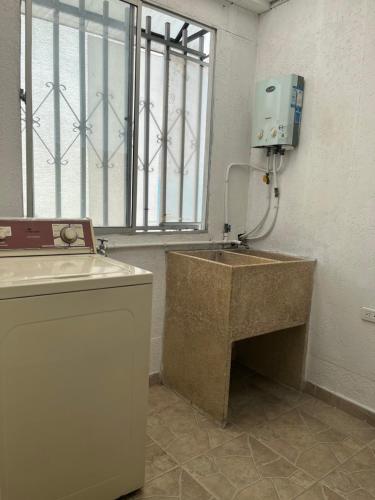 a bathroom with a sink and a window at Casa Familiar in Armenia