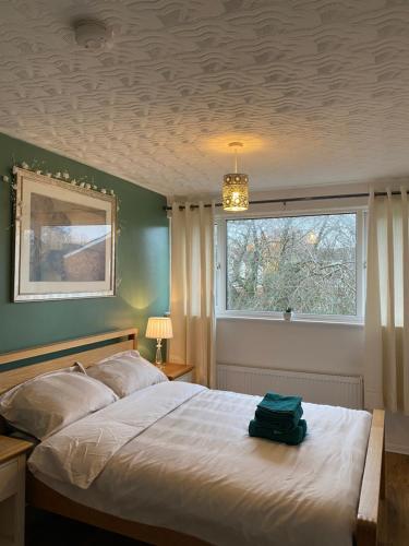 a bedroom with a large bed and a window at 1 Luxurious Double Bedroom with Private Shower in Reading