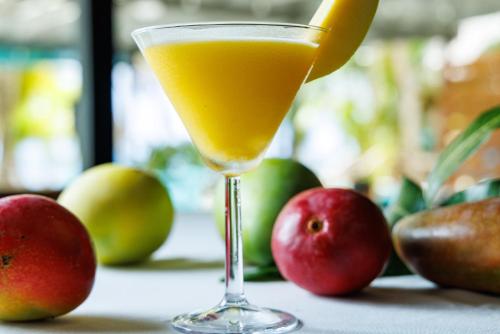 a glass of orange juice with apples on a table at Azure Del Mar in Maya Beach