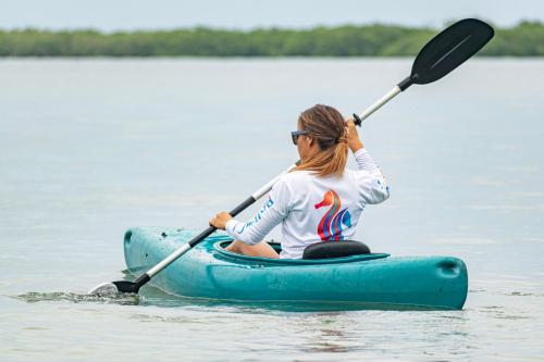 a woman in a kayak on the water at Azure Del Mar in Maya Beach