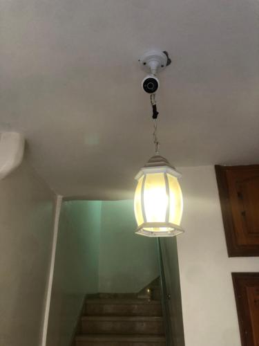 a light hanging from a ceiling with some stairs at Hay mohammadi agadir in Agadir
