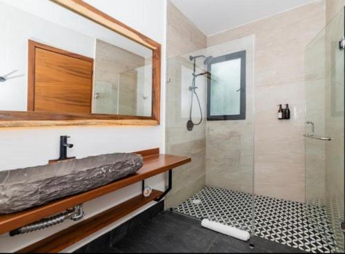 a bathroom with a sink and a shower with a mirror at New Villa 4BR private pool & jacuzzi TULUM Veleta in Tulum