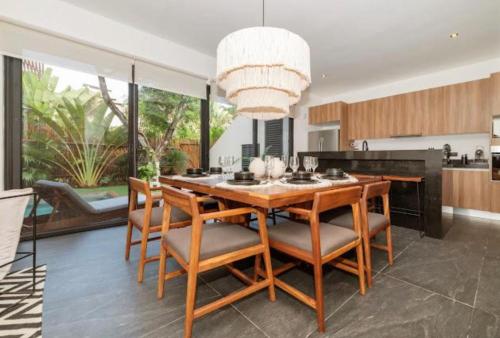 a dining room with a table and chairs at Villa Paradise Tulum Veleta 4BR private pool & jacuzzi in Tulum