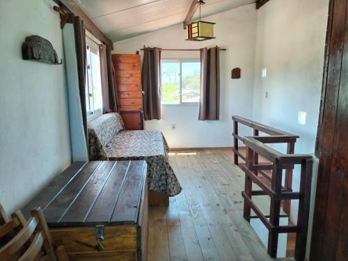 a living room with a bench and a window at Casa Nuestro Sueño in Punta Del Diablo