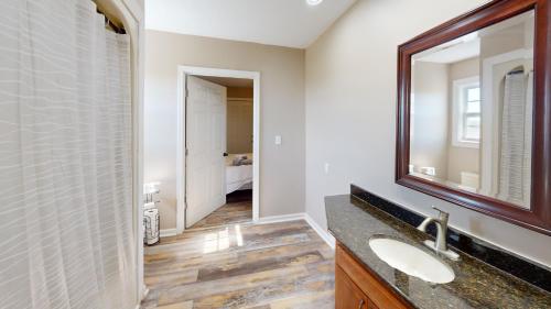 a bathroom with two sinks and a mirror at The Barn Apartment at Parkton Place in Hope Mills