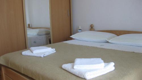a bedroom with two white towels on a bed at Apartment Anita in Vodice
