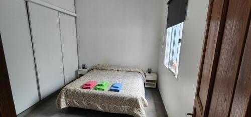 a bedroom with a bed with two slippers on it at 9 de julio in San Miguel de Tucumán