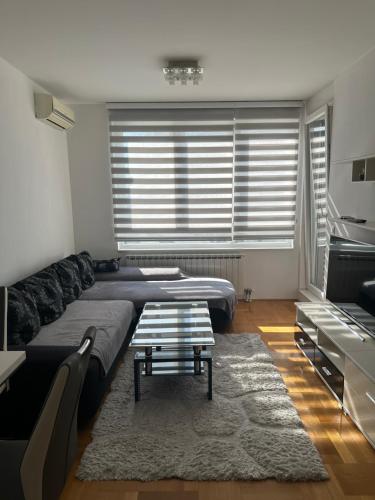 a living room with two beds and a coffee table at Pia Apartment -SelfCheckIn-free parking in Zagreb
