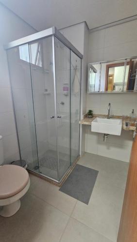 a bathroom with a shower and a toilet and a sink at Studio Barra Premium in Salvador