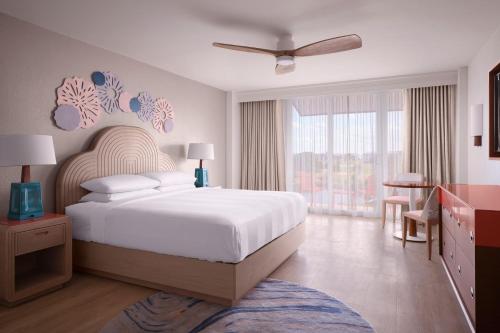 a bedroom with a large white bed and a window at Marriott Hutchinson Island Beach Resort, Golf & Marina in Stuart