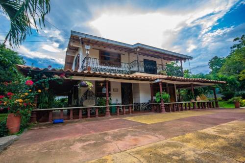 a house with a balcony on the front of it at Hotel San Sebastian del Tonusco in Santa Fe de Antioquia