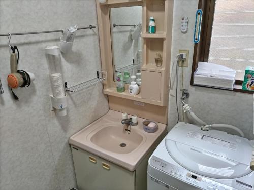 a small bathroom with a sink and a toilet at Southern Alps Kaikomagatake Foot of the Kaikoma in Hokuto