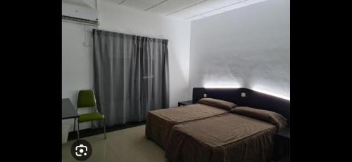 a bedroom with a bed and a desk and a window at HOTEL LA GUAREÑA in Castrillo de la Guareña