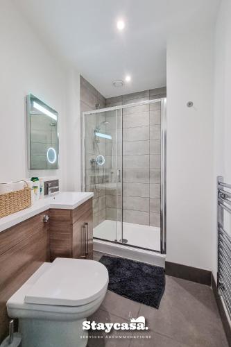 a bathroom with a shower and a toilet and a sink at Bright & Central Apt - With Great Transport Links in Stockport