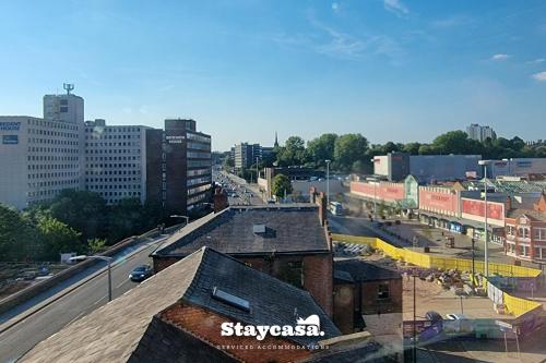 a view of a city with buildings and a street at Bright & Central Apt - With Great Transport Links in Stockport