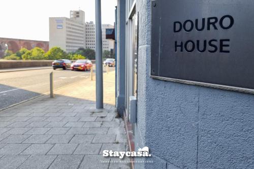 a sign for a douro house on the side of a street at Bright & Central Apt - With Great Transport Links in Stockport