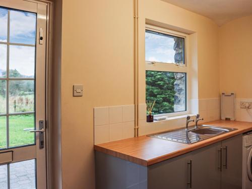 a kitchen with a sink and a window at Plas Madog in Llanuwchllyn