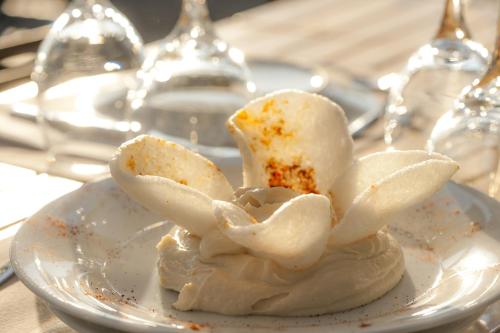 a white plate with a dessert on a table at Vincci EverEden in Anavissos