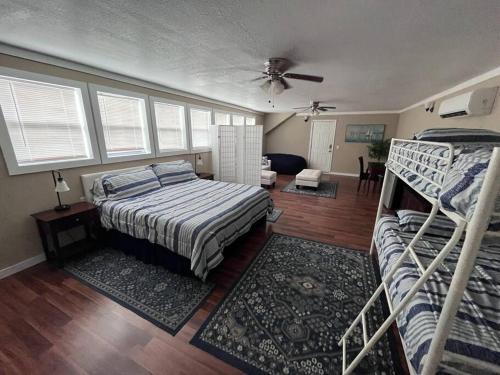 a bedroom with two bunk beds and a living room at Skinny Big House in Jefferson City in Jefferson City