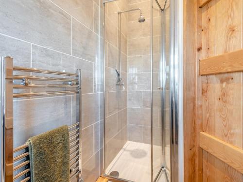 a bathroom with a shower with a glass door at The Old Greenhouse - Uk45328 in East Barkwith