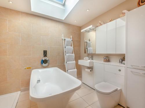 a bathroom with a toilet and a sink at Anchor Cottage in South Hayling