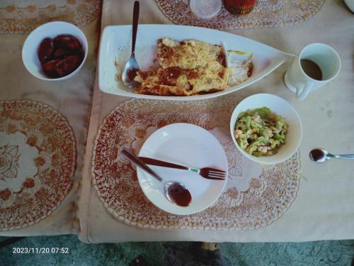 a table topped with plates and bowls of food at JUNGLE GYM LA UNION Prana fan kubo 2 pax in Rimus