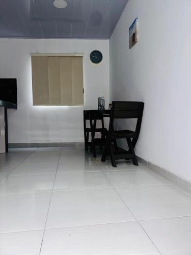 a room with a table and a chair in it at Apartamentos turísticos Mirador de la 20 in San Andrés