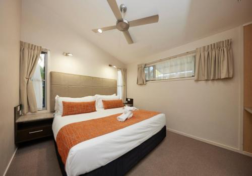 a bedroom with a bed with a stuffed animal on it at Brisbane Holiday Village in Brisbane