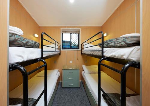 a small room with two bunk beds in it at Brisbane Holiday Village in Brisbane