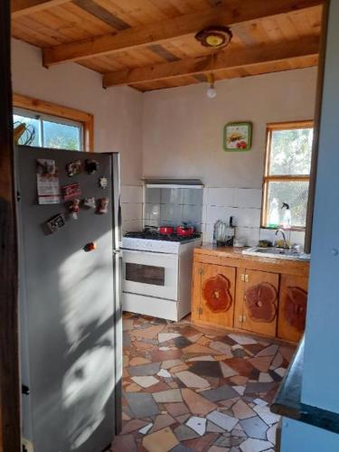 a kitchen with a stainless steel refrigerator in a room at Casa campestre 6 personas in San Antonio