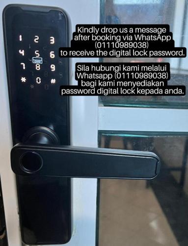 a black door handle with a sign on it at K SUITES HOTEL in Chabang Tiga
