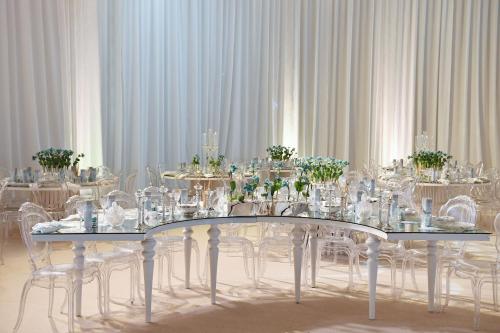 a dining room with a table with glasses and chairs at The St. Regis Abu Dhabi in Abu Dhabi