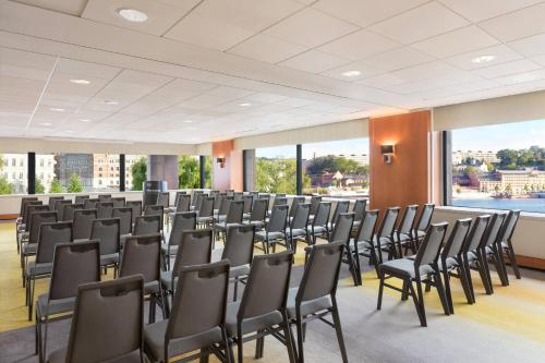 a large room with chairs and large windows at Sheraton Stockholm Hotel in Stockholm