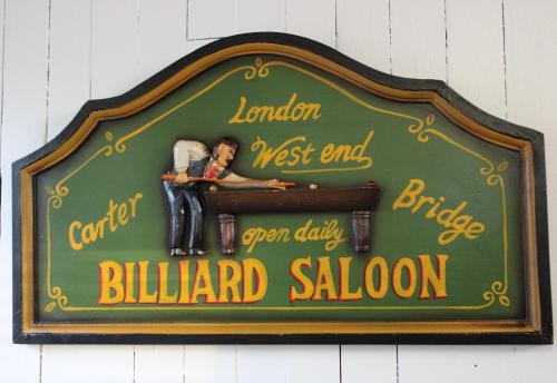 a sign for a billard saloon on a wall at Private Bright Modern Studio! Queen bed ! in Victoria